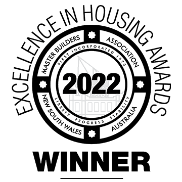 Circular black and white badge reading “Excellence in Housing Awards 2022 Winner,” with “Master Builders Association New South Wales Australia” around the edge. Faint building illustration in the background.